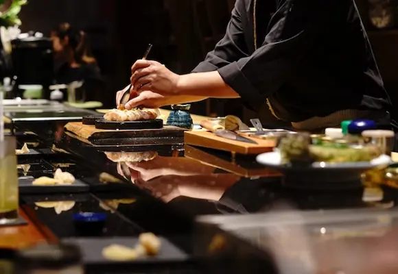 sushi chef making uni and nigiri