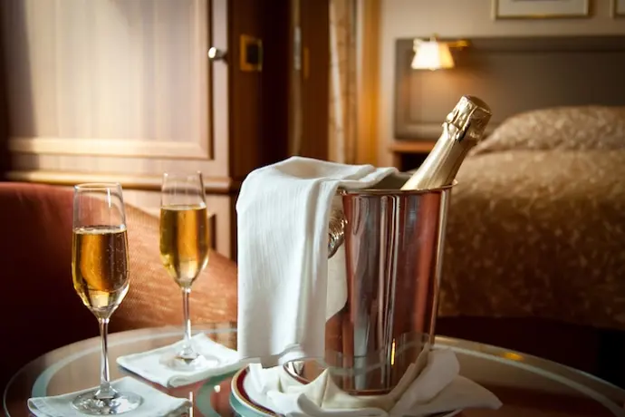 luxury hotel room with a focused image of a champagne bottle and champagne flutes